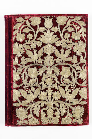 EMBROIDERED BINDING An album containing approximately 150 blank leaves, cover with a bold design of flower and foliage branching from a composite central stem, with birds perched on the branches, embroidered in gold thread on red velvet