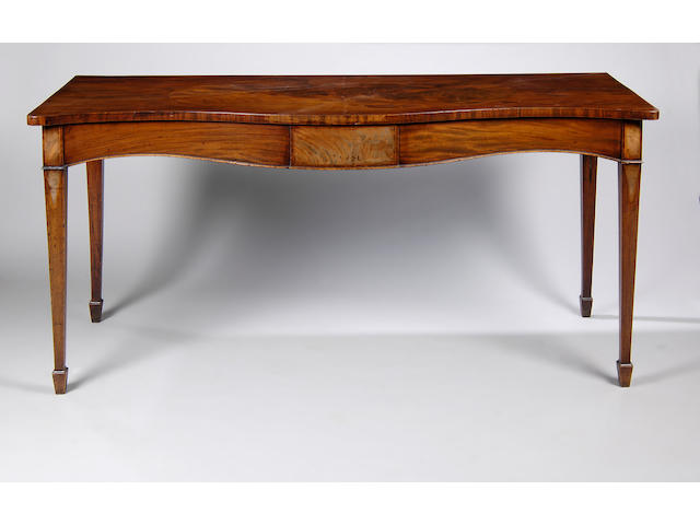 A good George III mahogany serpentine serving table,