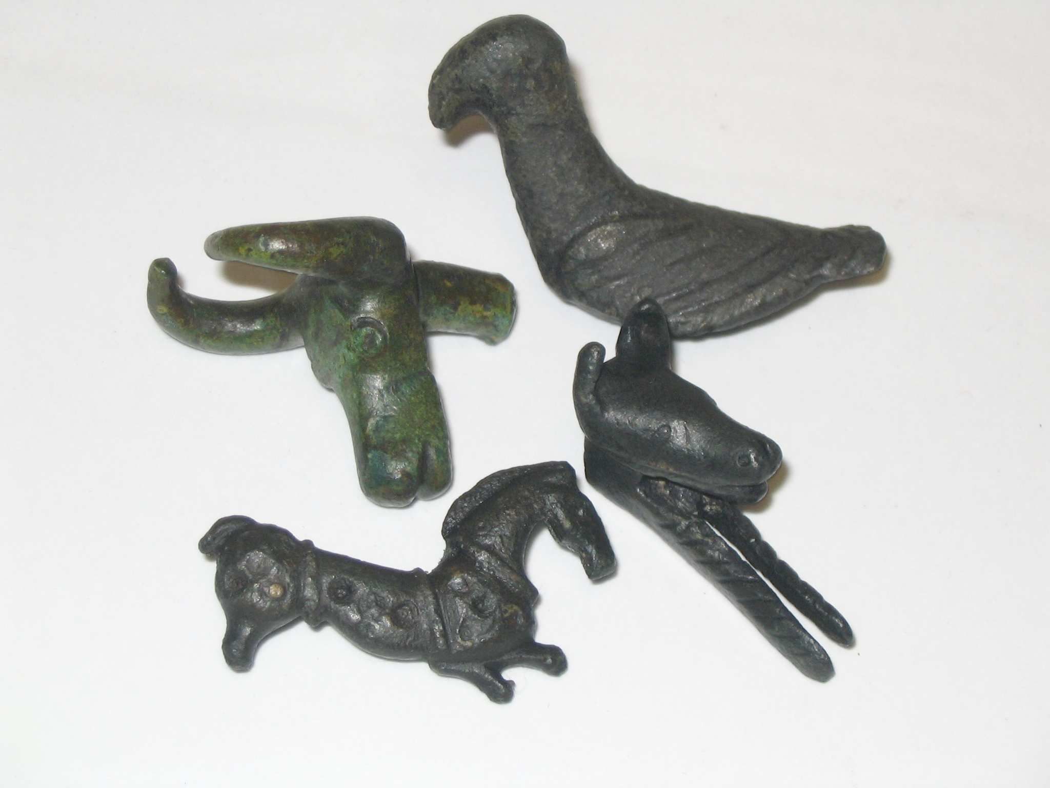 Four bronze zoomorphic attachments