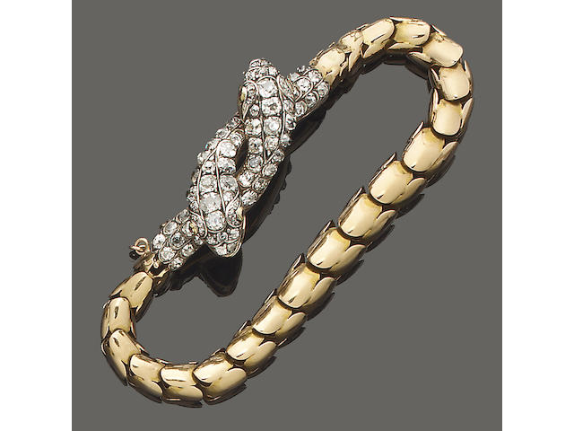 A gold and diamond snake bracelet,