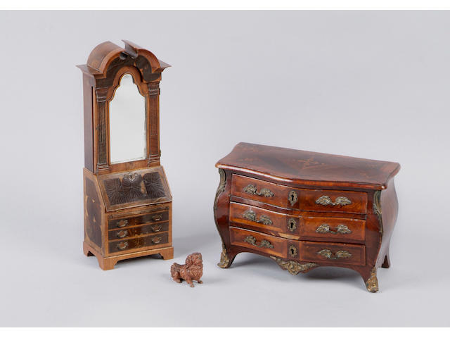 A Louis XVI kingwood parquetry miniature commode Of bombe outline, fitted with three drawers with rococo gilt metal handles and key plates and with gilt metal angle mounts and sabots, 30cm.