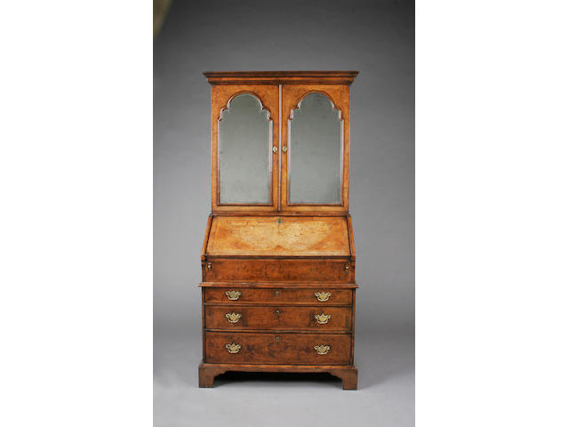 A George I burr and figured walnut, cross and feather banded bureau cabinet