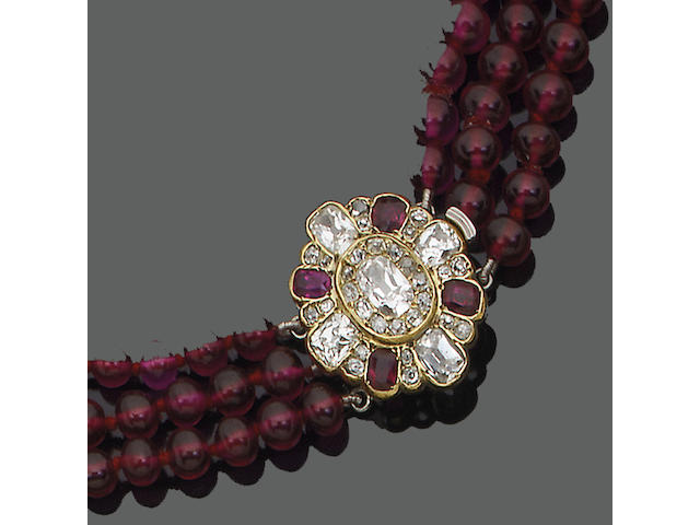 A late 19th century ruby and diamond clasp, circa 1880 and synthetic ruby bead necklace
