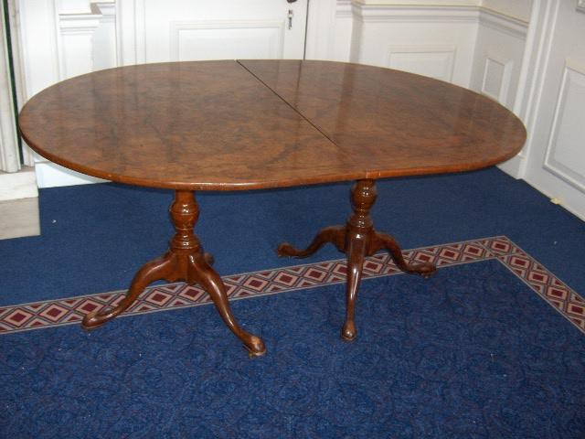 A George III style burr walnut twin pedestal dining table