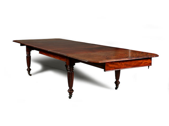 A good William IV/early Victorian mahogany draw-out extending dining table