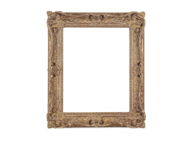 A Louis XV style carved, pierced, swept and gilded frame