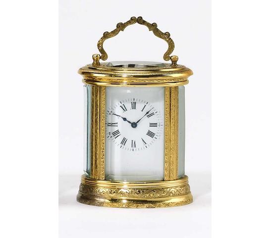 A good early-20th Century French engraved oval miniature carriage clock,