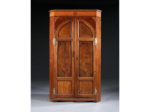 A late 18th Century inlaid mahogany corner cupboard