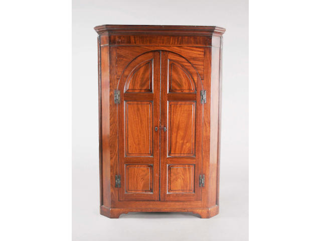 A George III mahogany low floorstanding corner cupboard of good colour,