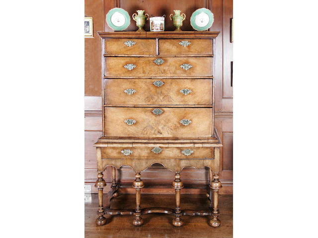 An early 18th century and later figured walnut chest on stand