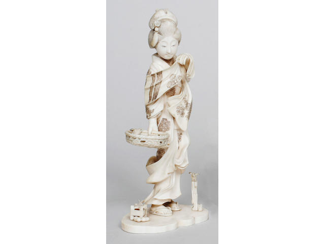 A Japanese carved and decorated ivory one piece tusk section figure