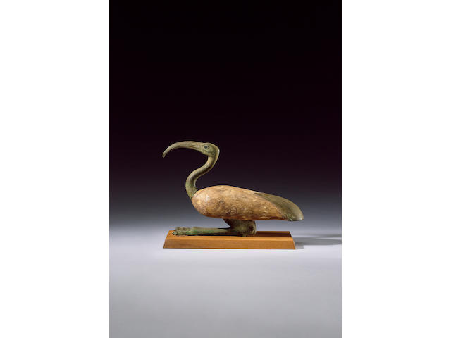 An Egyptian bronze and wood seated ibis