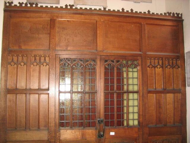 A pair of carved oak and glass panel doors
