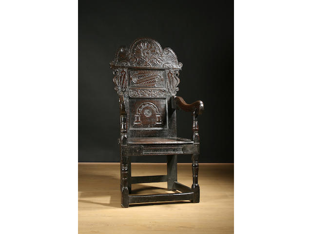 A mid-17th Century carved oak high back Wainscot elbow chair, Yorkshire
