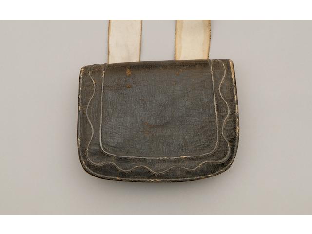A Most Important Late 18th Century Officers Ammunition Pouch and Belt The pouch with internal wooden rack for six cartridges, is of black leather, the flap with additional covering of black Skiver and narrow silver wire decoration, comprising two lines forming a border, and a wavy line of lace within this border, the pouch 6" x 5", the belt of soft white buckskin over tan skiver, this with simple iron buckle, the ends anchored to the under part of the box via sewn buckles and another returning strap, the belt 1 5/8", the style suggests a light company officer c1780-1800, slight overall wear but otherwise very good condition for age.