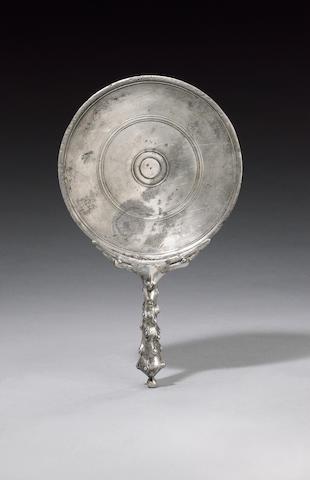 A Roman silver mirror with a Herculean club handle
