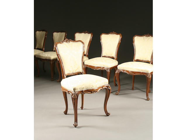 A set of six French walnut dining chairs and a similar marble top dining table,