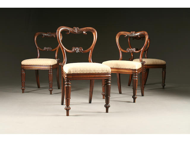 A set of four Victorian rosewood kidney-back dining chairs