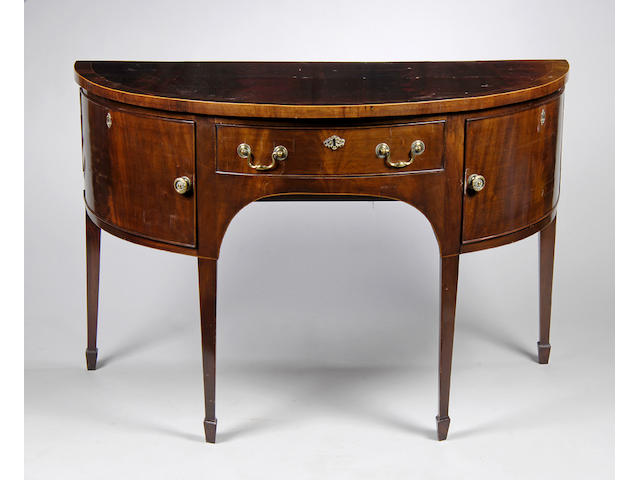 A George III style mahogany and rosewood crossbanded demi-lune sideboard