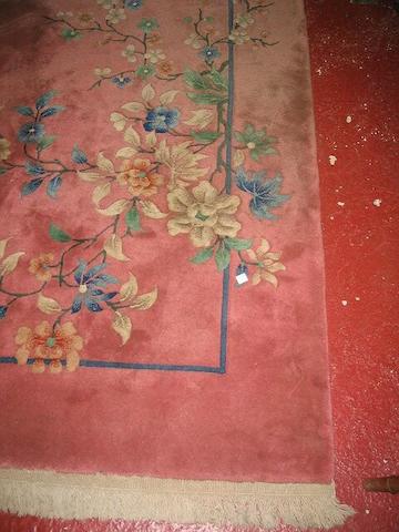 A 20th Century pink ground Chinese carpet