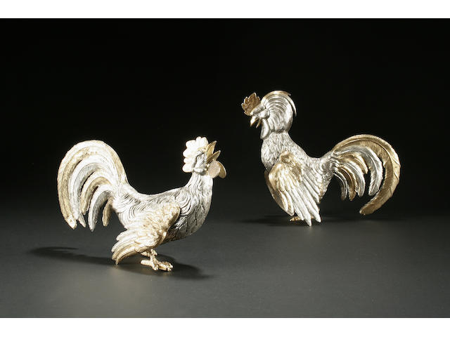 A pair of Continental silver-gilt and silver fighting cocks bears control marks