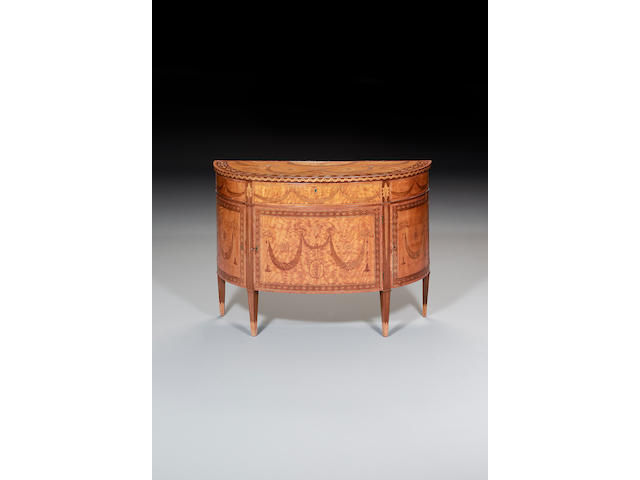 A fine George III satinwood, tulipwood crossbanded, purplewood, sycamore and harewood marquetry demi-lune Commodein the manner of Mayhew and Ince