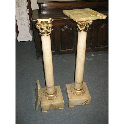 A pair of 20th Century onyx and gilt brass torchere