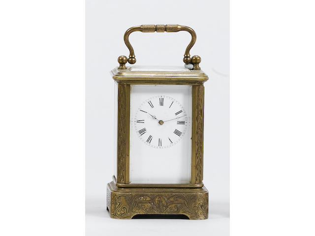 A late-19th Century French gilt brass miniature carriage timepiece in a stylised case, the movement numbered 82, cylinder platform escapement, enamel Roman dial in a stylised case with elaborate stepped cornice and Greek-key pattern handle, 10cm high.