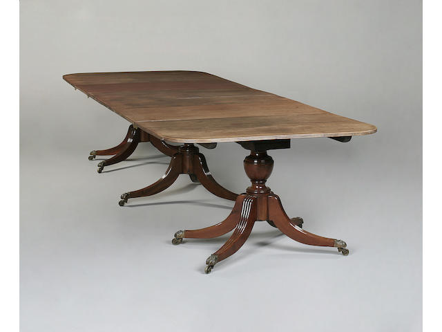 A Regency triple pedestal mahogany dining table