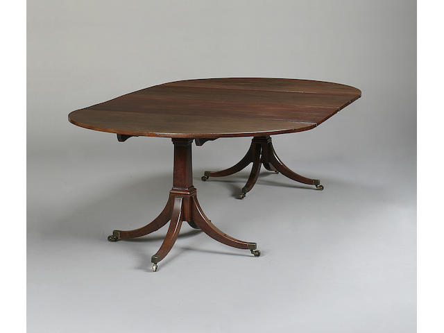 A 19th century mahogany twin pillar dining table