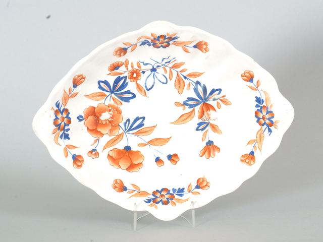 A Chamberlains Worcester part dinner service painted in the Imari palette with flowers, comprising two tureens and covers, three dishes, a soup plate and twenty five dinner plates; together with an ironstone Japan pattern jug.