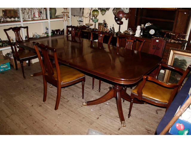 An early 19th century style mahogany dining table,
