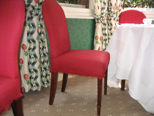 A matched set of fourteen stained beech framed dining chairs