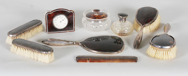 A mounted tortoiseshell eight piece dressing table set and matching time-piece By Walker and Hall, Birmingham, 1932,  (9)