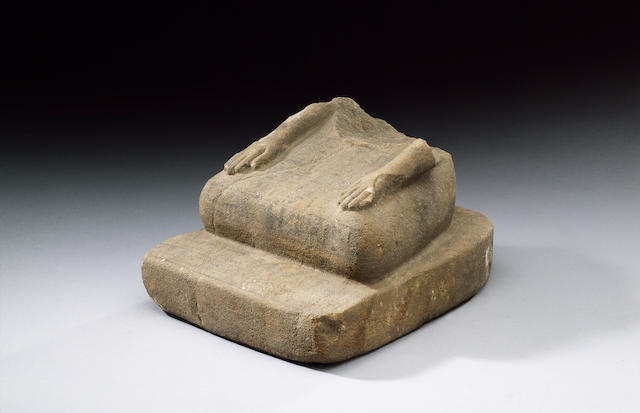 An Egyptian sandstone seated scribe statue fragment