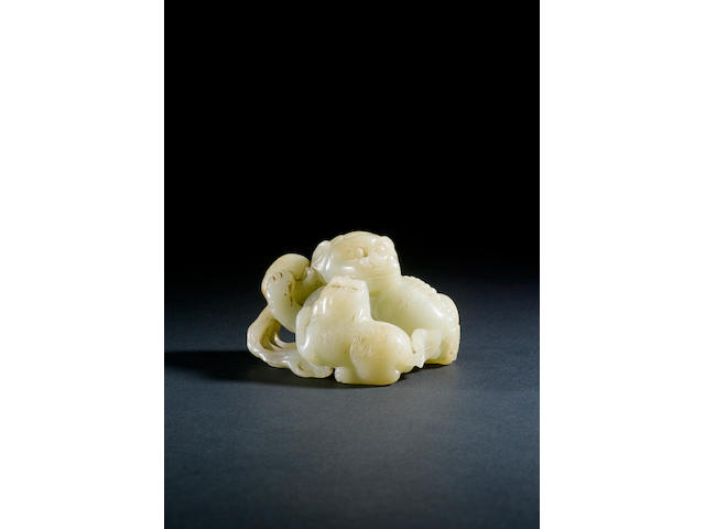 A celadon jade carving of two recumbent lions