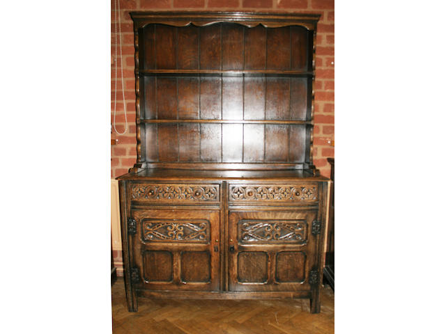 A 20th century, 17th century style oak dresser and two tier rack,