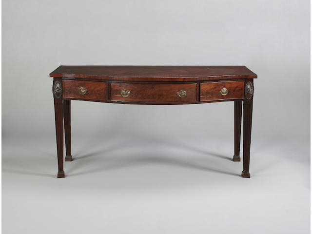 A George III style mahogany serpentine serving table