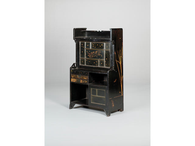 An ebonised and parcel gilt secretaire writing cabinet