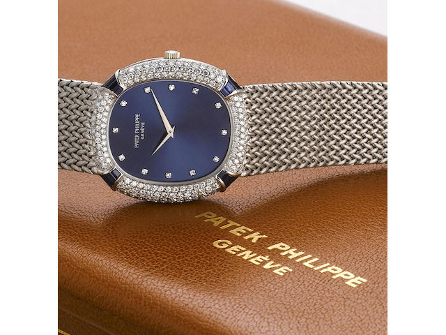 Patek Philippe. A fine and rare 18ct white gold automatic bracelet watch set with diamonds and sapphires, together with its Patek Philippe fitted watch/jewellery box and original Certificate of Origin Ref:3609/3, Case No.2758735, Movement No.1287317, Made in 1976 and Sold on the 21st of July 1977