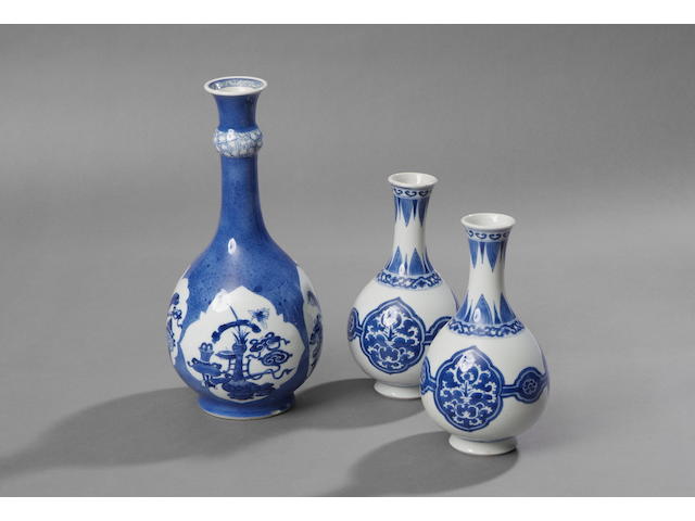 A pair of Kangxi blue and white ovoid slender neck vase The sides with stylised foliate cartouche decoration, 19cm high. (2)