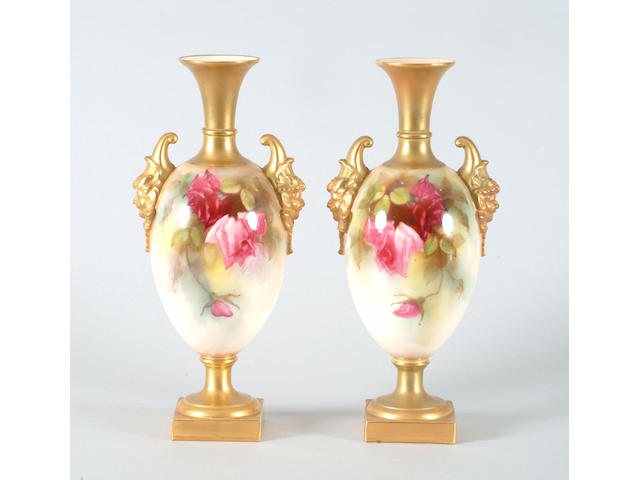 A pair of Royal Worcester urn shaped vases