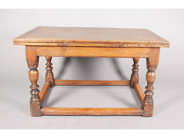 A 17th century style oak drawleaf refectory table