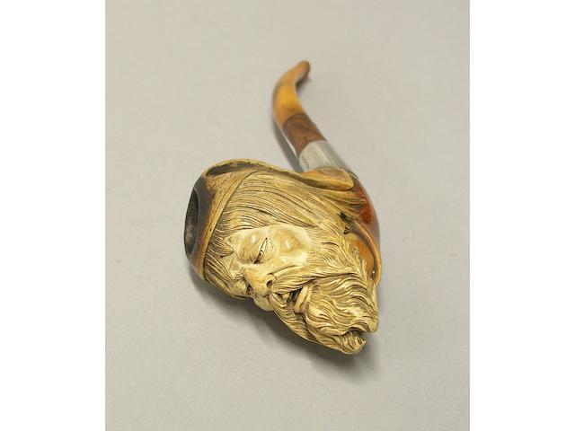 A carved meerschaum and amber pipe