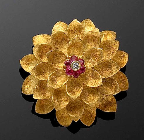 A gold ruby and diamond flower brooch