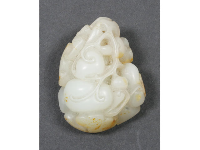 A mottled white jade carved as a group of fruit.