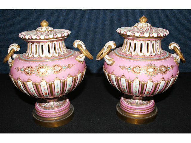 A pair of Sevres style porcelain and gilt metal mounted vases and covers