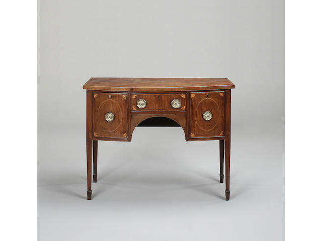 A George III mahogany and inlaid bowfront sideboard