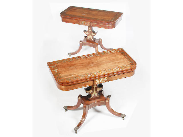 A pair of Regency rosewood and brass inlaid fold-over card tables,