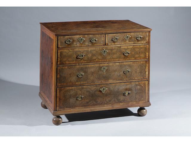 A William and Mary and later reconstructed oyster veneered and holly line inlaid chest Of two short and three long drawers, on bun feet, 97cm wide.